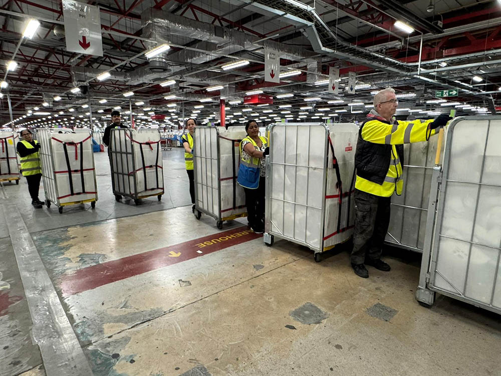 Workers moving trolleys.