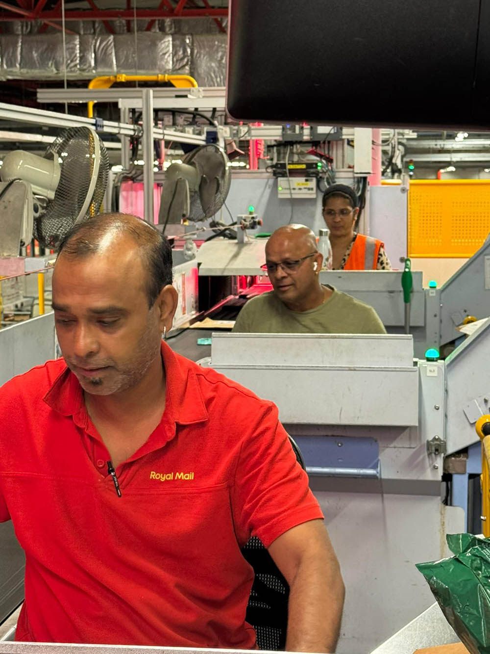 Postal workers working with machinery.