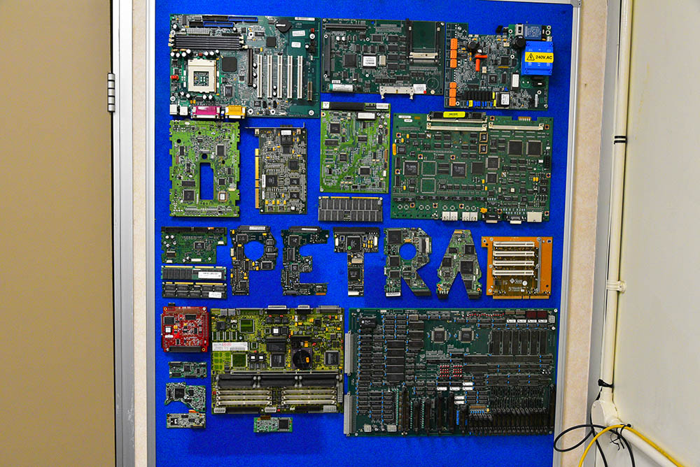 A display of computer chips mounted on a blue board with the acronym 'PETRA' on display in the middle of the board.
