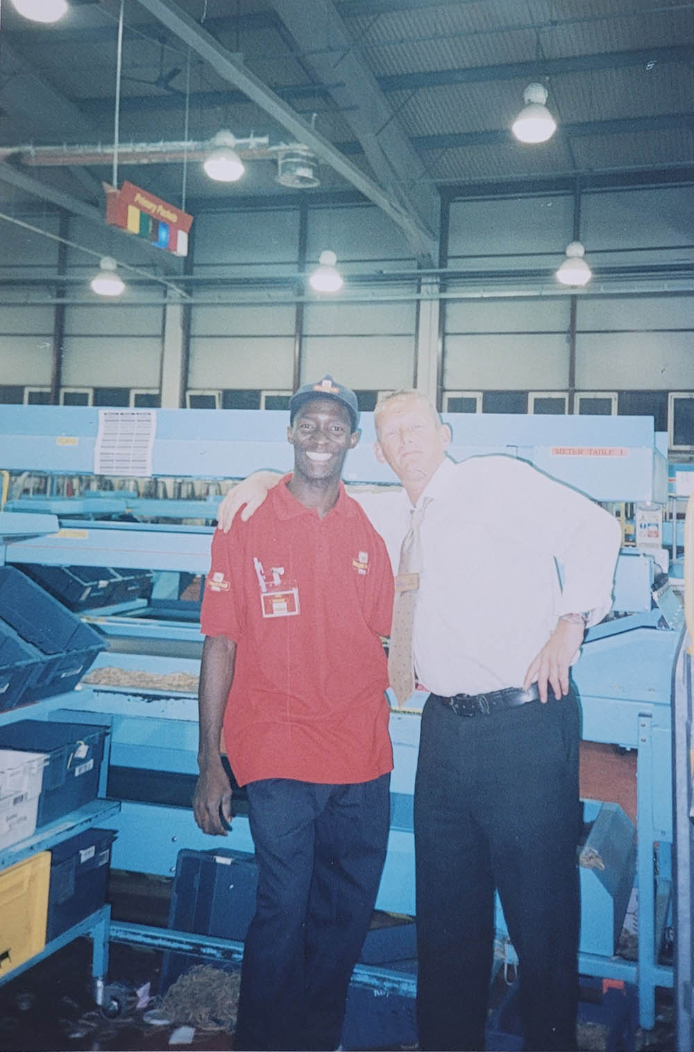 A younger Ebenezer posing for a photo with a colleague in the old mail centre.