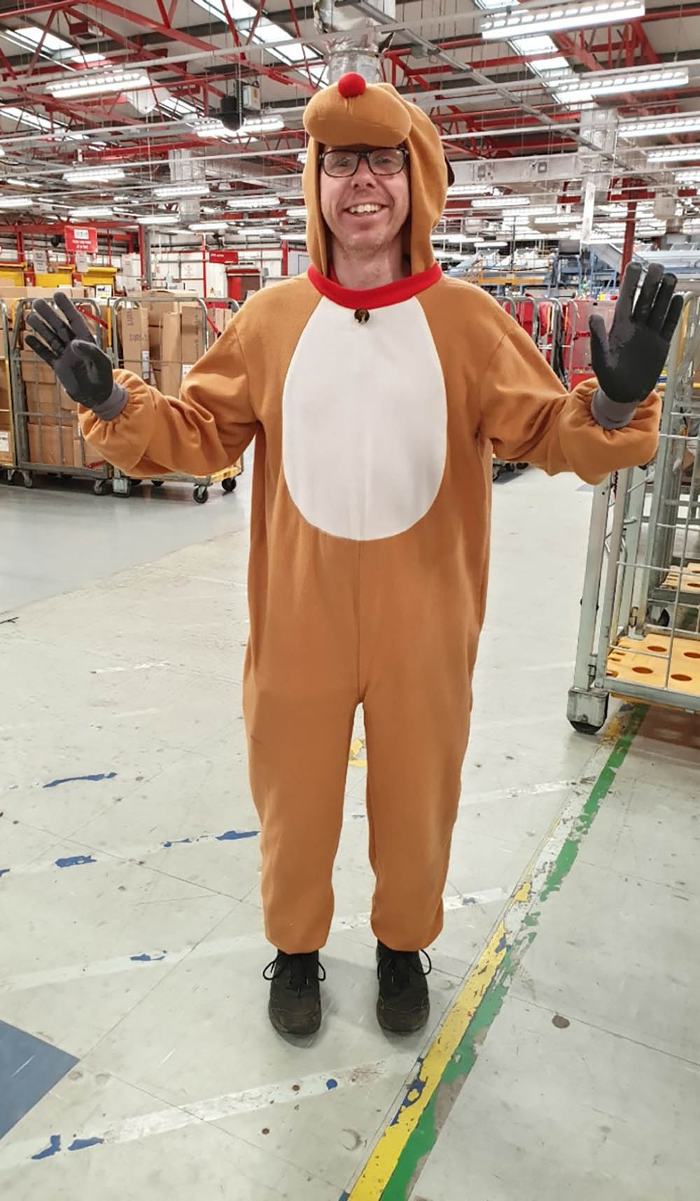 A man in costume, dressed up as a reindeer.