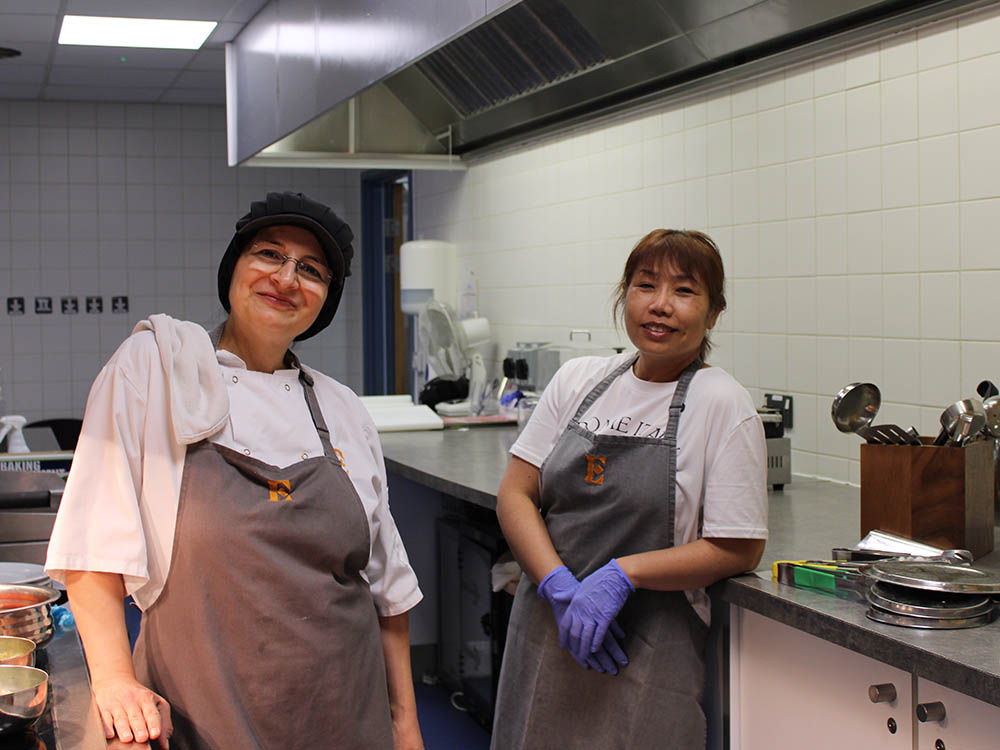 Uniformed workers by the counter at the canteen.