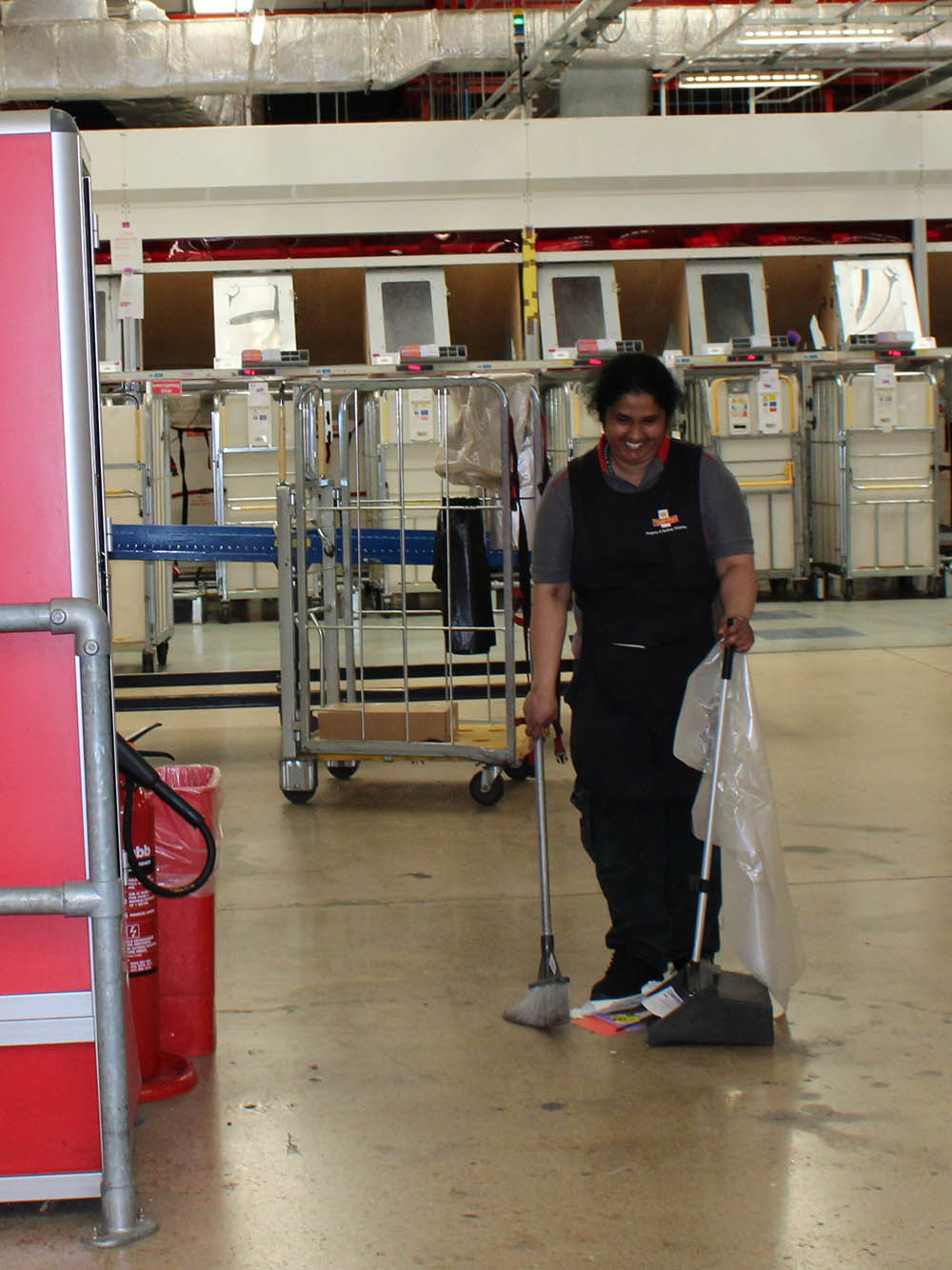 A cleaner with trolley and equipment in the Swindon mail centre.