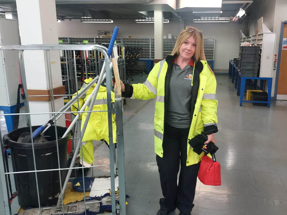 A cleaner with trolley and equipment in the Swindon mail centre.