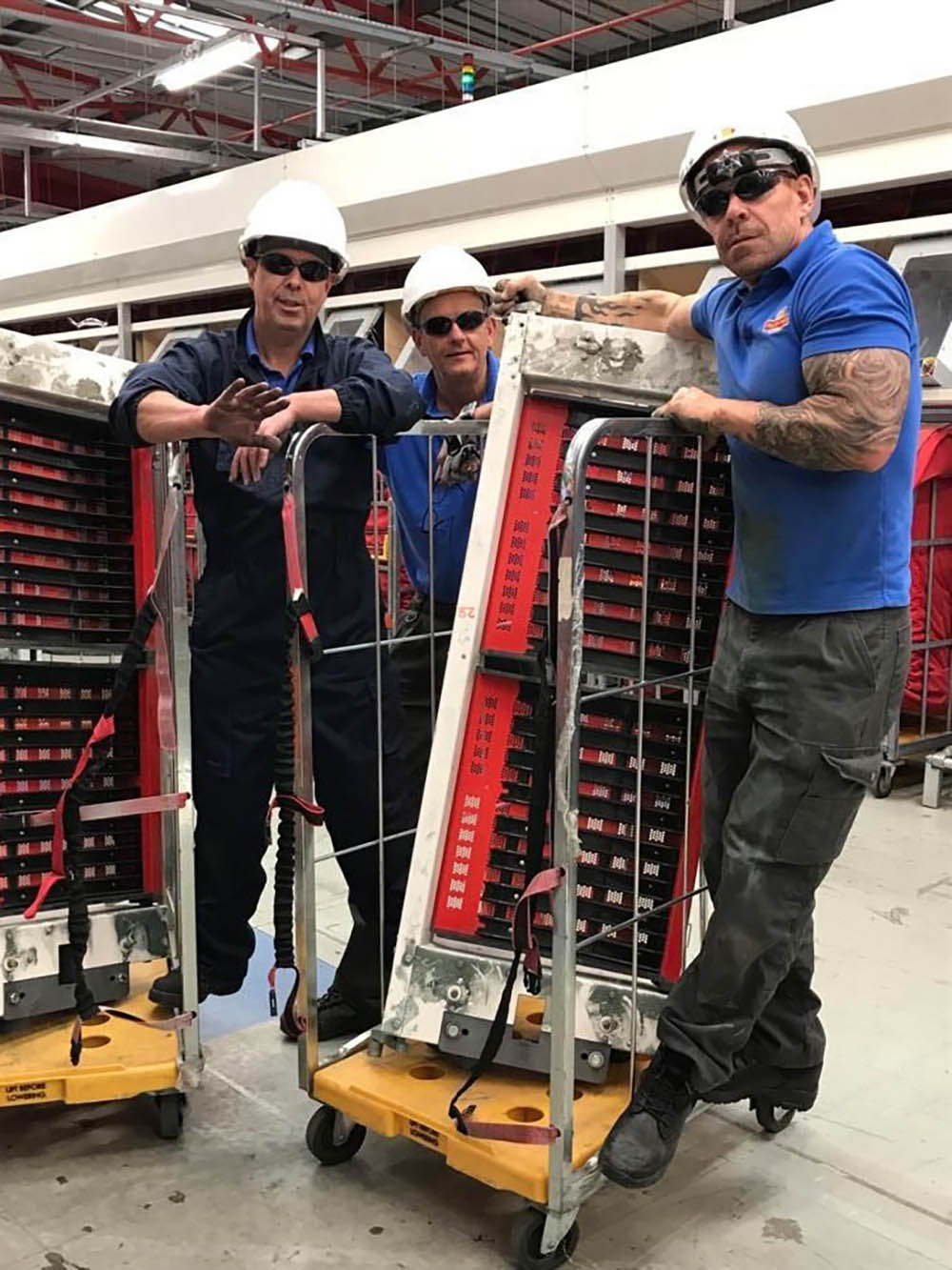 Three engineers working with machinery.