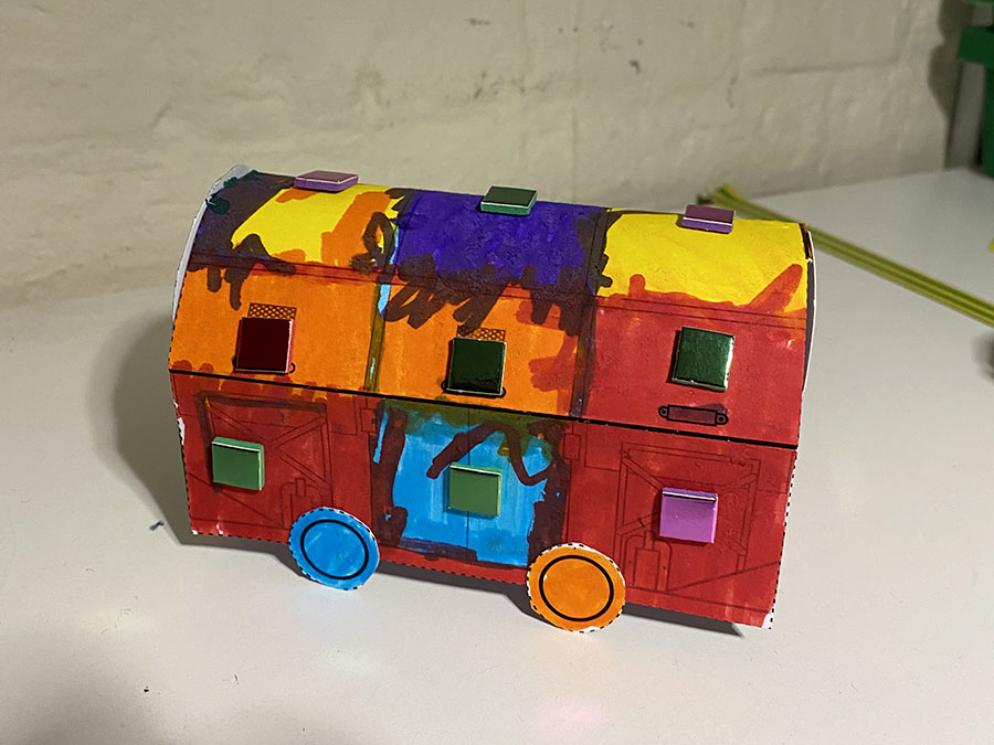 A colourful paper model of a Mail Rail train.