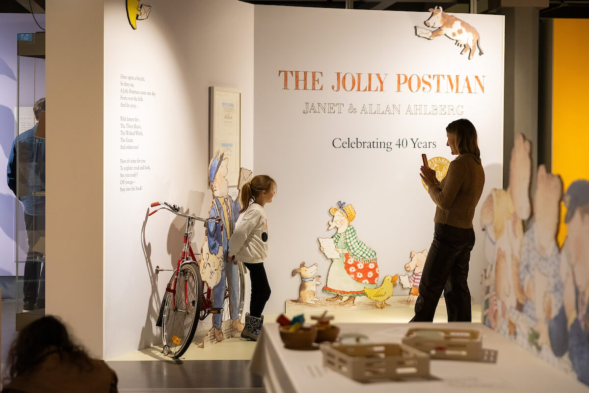 A family playing with props at a museum exhibit.